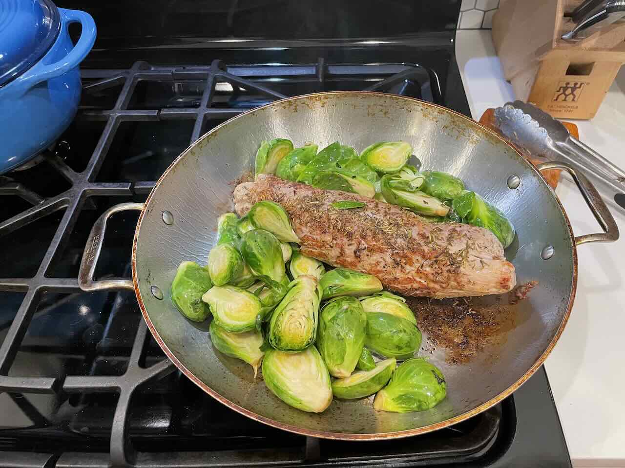 Put the oiled sprouts in the pan with the meat.